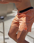 Flow shorts in Desert Orange, designed for hot yoga, featuring moisture-wicking fabric and a quick-drying inner liner.
