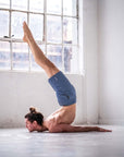 Man practicing a movement in 4-way stretch Swerve Shorts - Heather Navy, showcasing flexibility and comfort in training.
