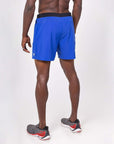 Back view of a model wearing lightweight flow shorts in blue, ideal for hot yoga and active training.
