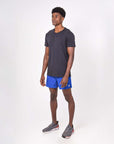 Man wearing lightweight flow shorts for hot yoga, featuring moisture-wicking and quick-drying fabric.