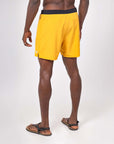 Flow shorts - Saffron view from the back, showcasing the vibrant design and comfortable fit for yoga and workouts.