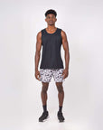 Man wearing Flow shorts in Snow Leopard design with a black tank top, showcasing fitness apparel for hot yoga.