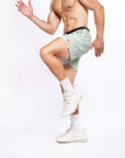 Flow shorts in lichen color worn by a man, showcasing flexibility during a workout.