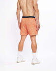 Flow shorts in Desert Orange, designed for hot yoga with moisture-wicking fabric and a comfortable fit.