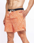 Flow shorts in Desert Orange with moisture-wicking fabric for hot yoga and training.
