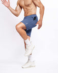 Model showcasing 4-way stretch swerve shorts in heather navy, perfect for active movement and cross training.