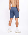 Back view of a man wearing 4-way stretch Swerve Shorts in Heather Navy, showcasing comfort and fit.