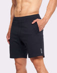 Model wearing 4-way stretch Swerve Shorts in Crow Black, showcasing comfort and flexibility for active movement.
