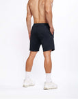 Model showcasing 4-way stretch Swerve Shorts in Crow Black from the back, highlighting comfort and flexibility.