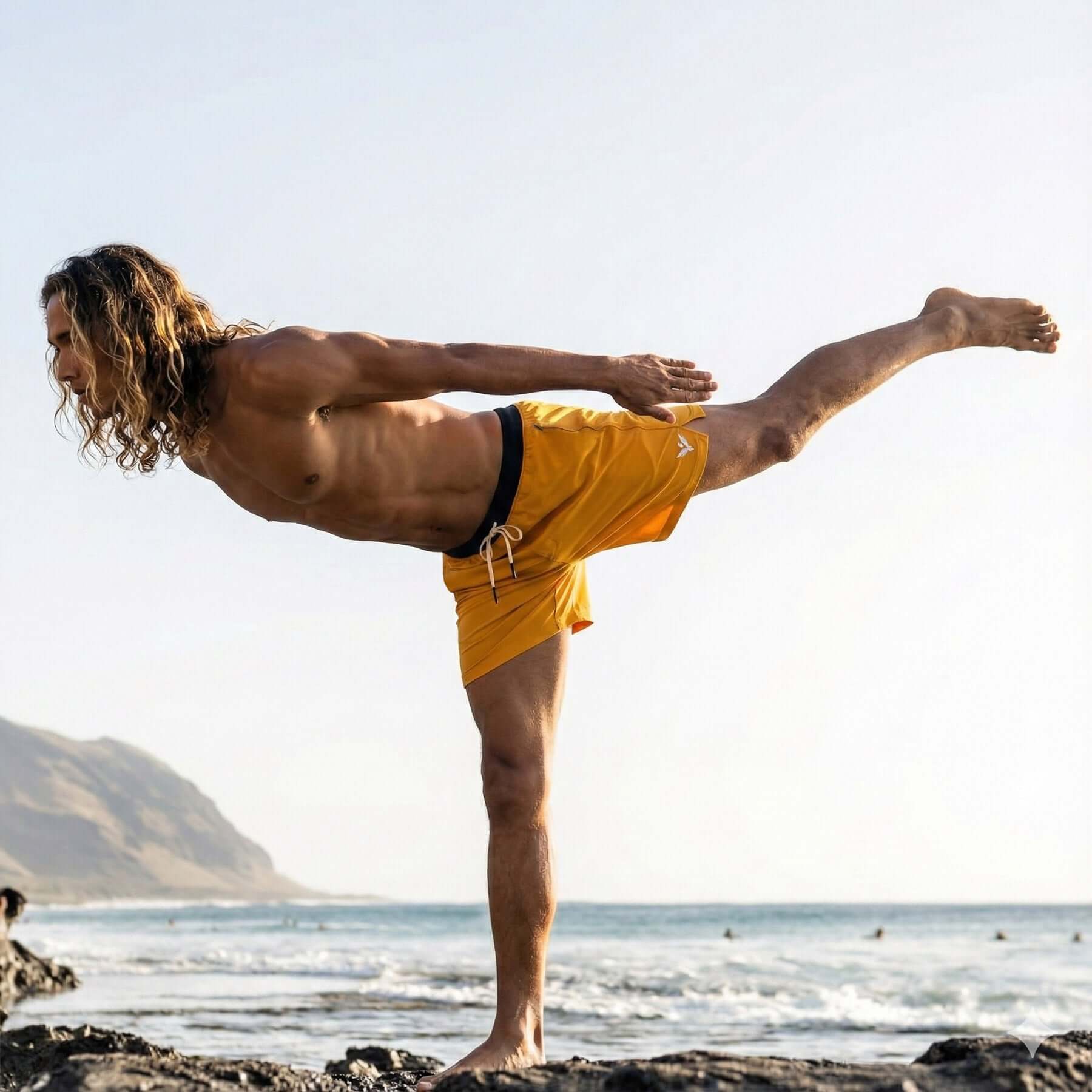 Man practicing yoga in Flow shorts - Saffron by the beach, showcasing flexibility and movement.